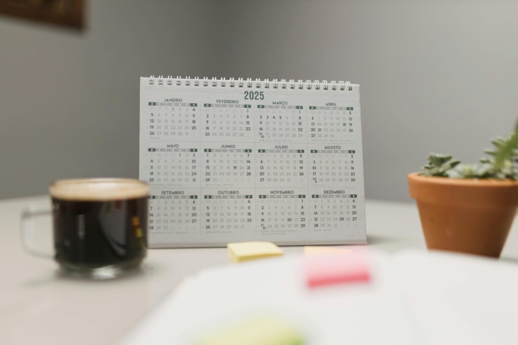 pexels-photo-29509456-29509456 A 2025 desk calendar with coffee and succulent, ideal for planning and office decor.