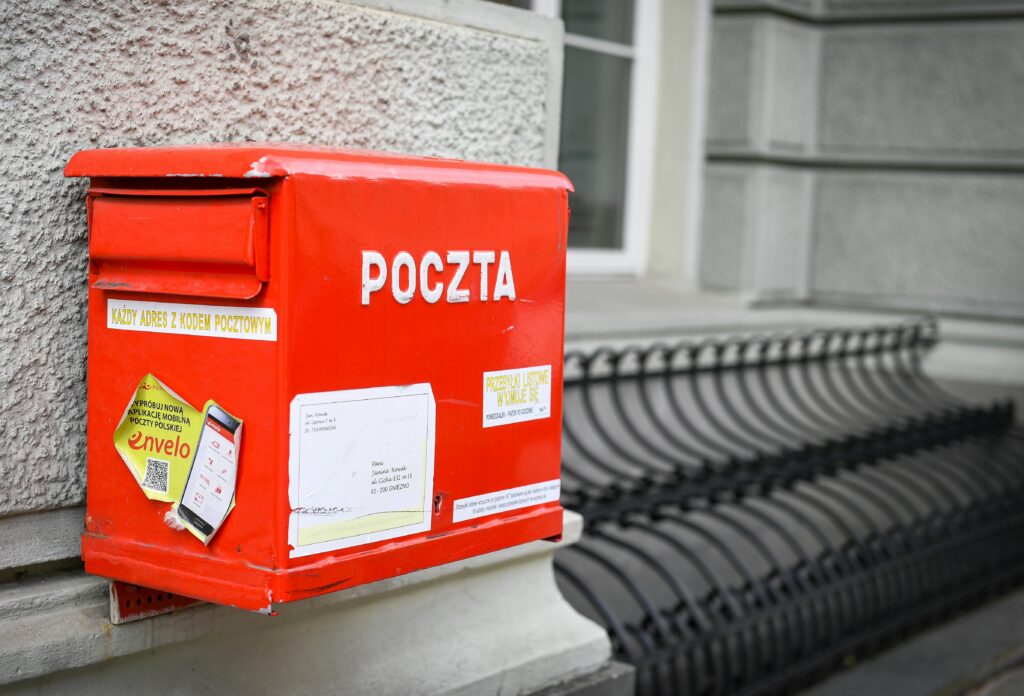 pexels-photo-35734777-35734777 Close-up of a traditional red Polish mailbox on a historic street in Warsaw.